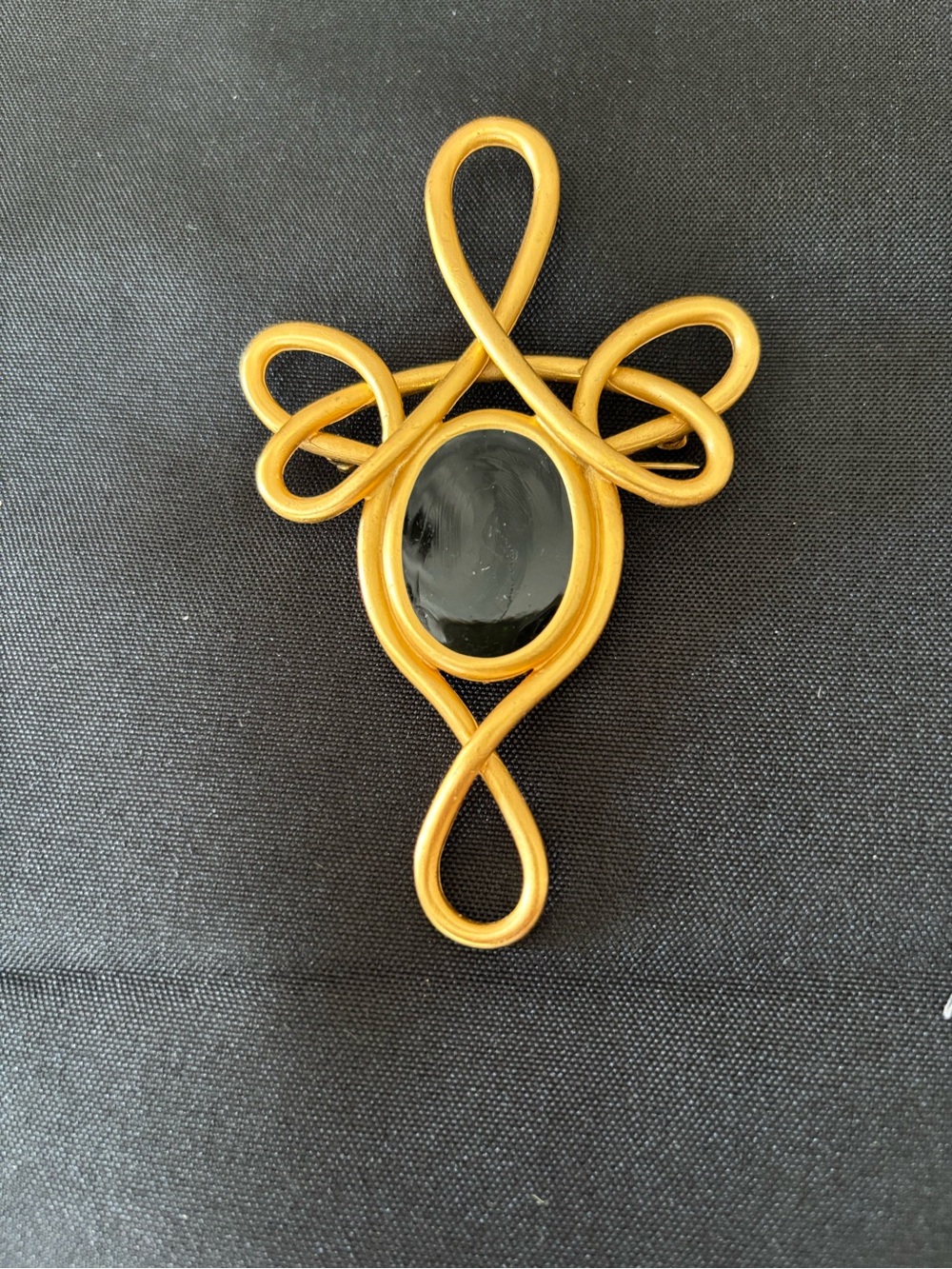 Gold Tone Swirl Brooch with Black Cabochon